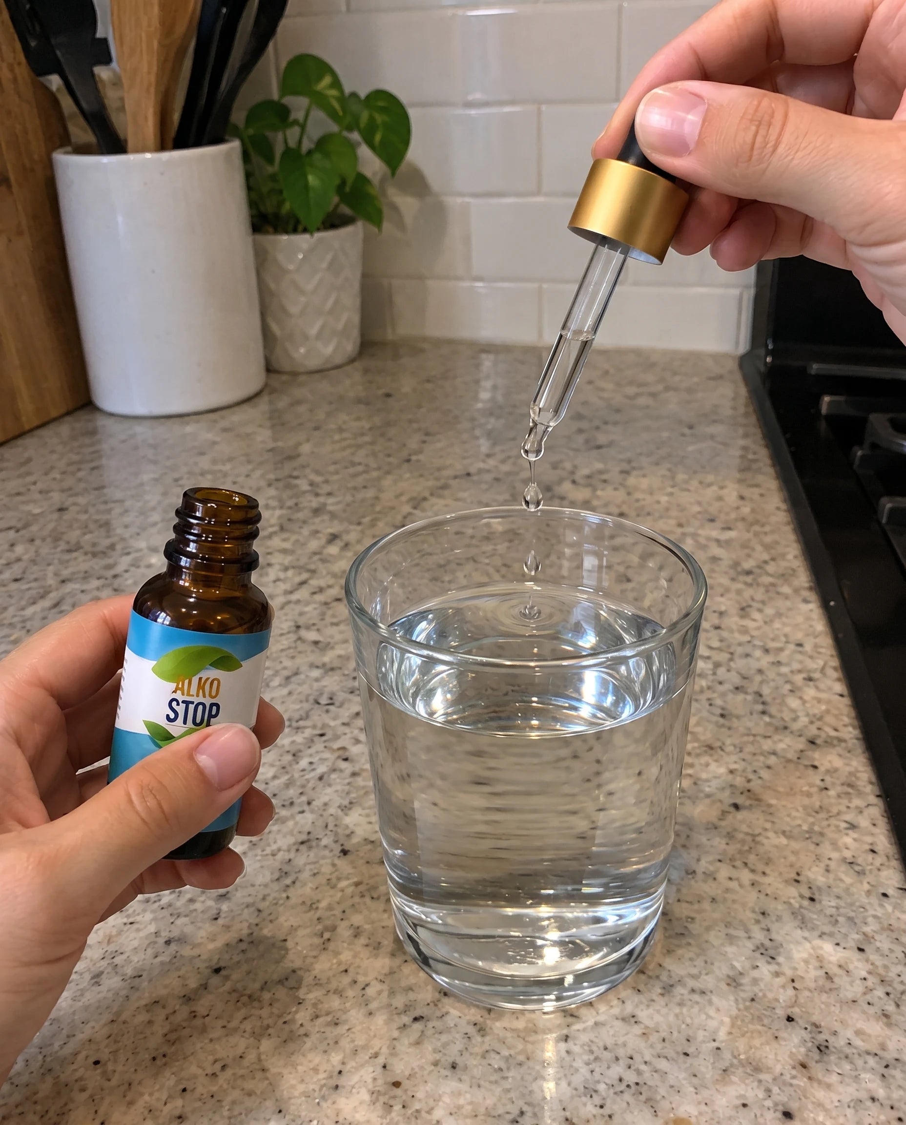 A dropper of AlkoStop being squeezed into a glass of water