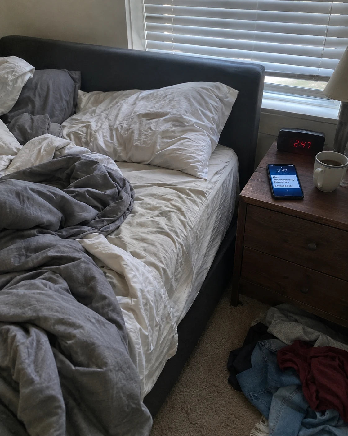 Unmade bed, a phone lit up with a missed call from Mom, cold untouched coffee, an alarm clock reading an ambiguous time