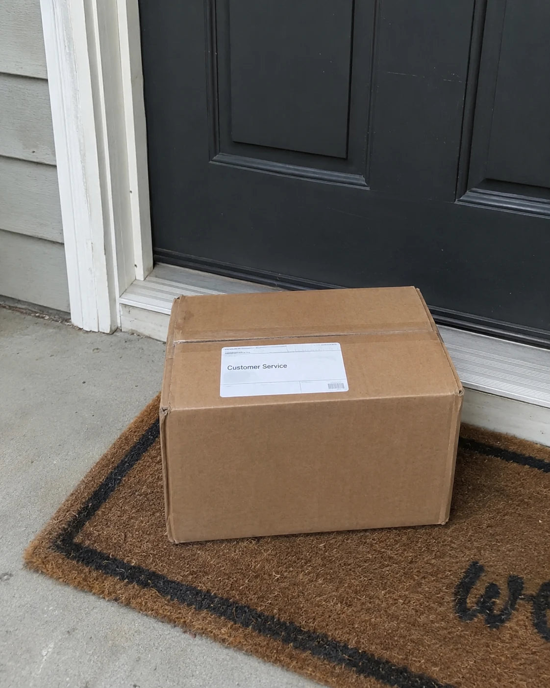 Plain unmarked shipping box on a doorstep