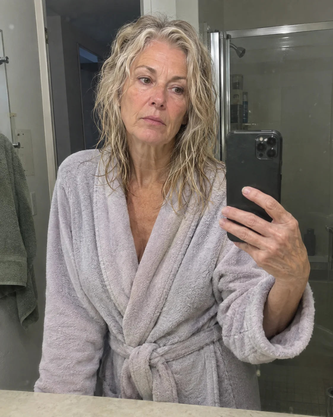 Diane looking at her own reflection in the bathroom mirror