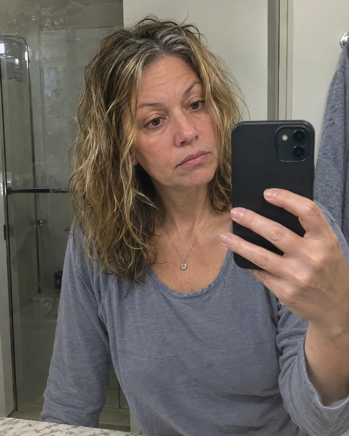Woman's tired reflection in a bathroom mirror in the morning