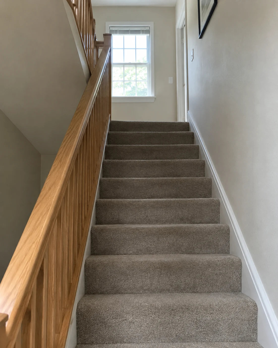 An empty home staircase viewed from the bottom step