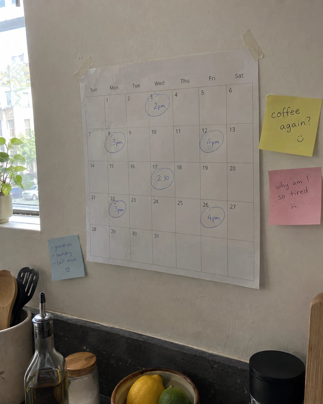 Kitchen wall calendar with several afternoon times circled and handwritten sticky notes nearby