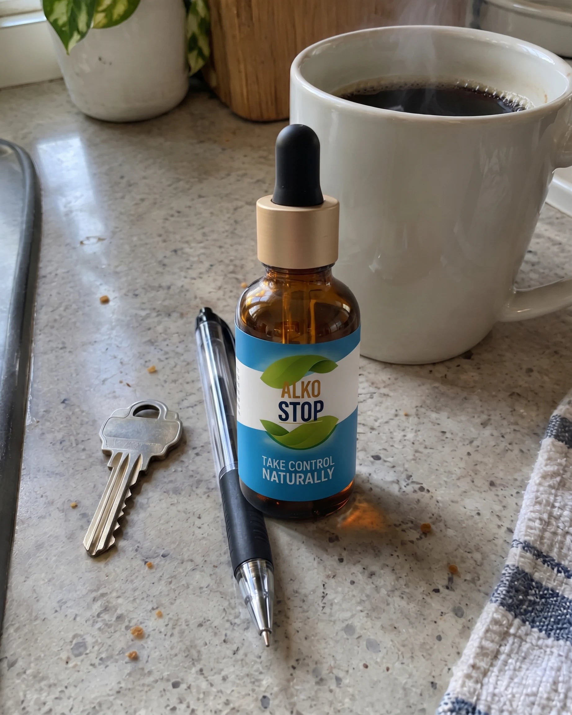 AlkoStop dropper bottle next to a morning coffee on a kitchen counter