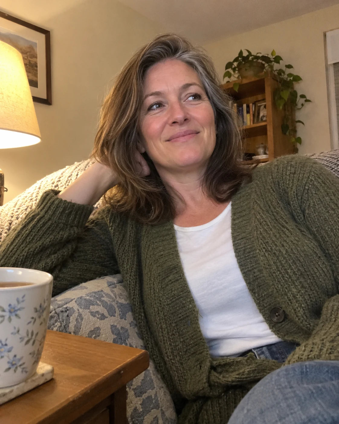 Woman relaxed on her couch in the evening with tea