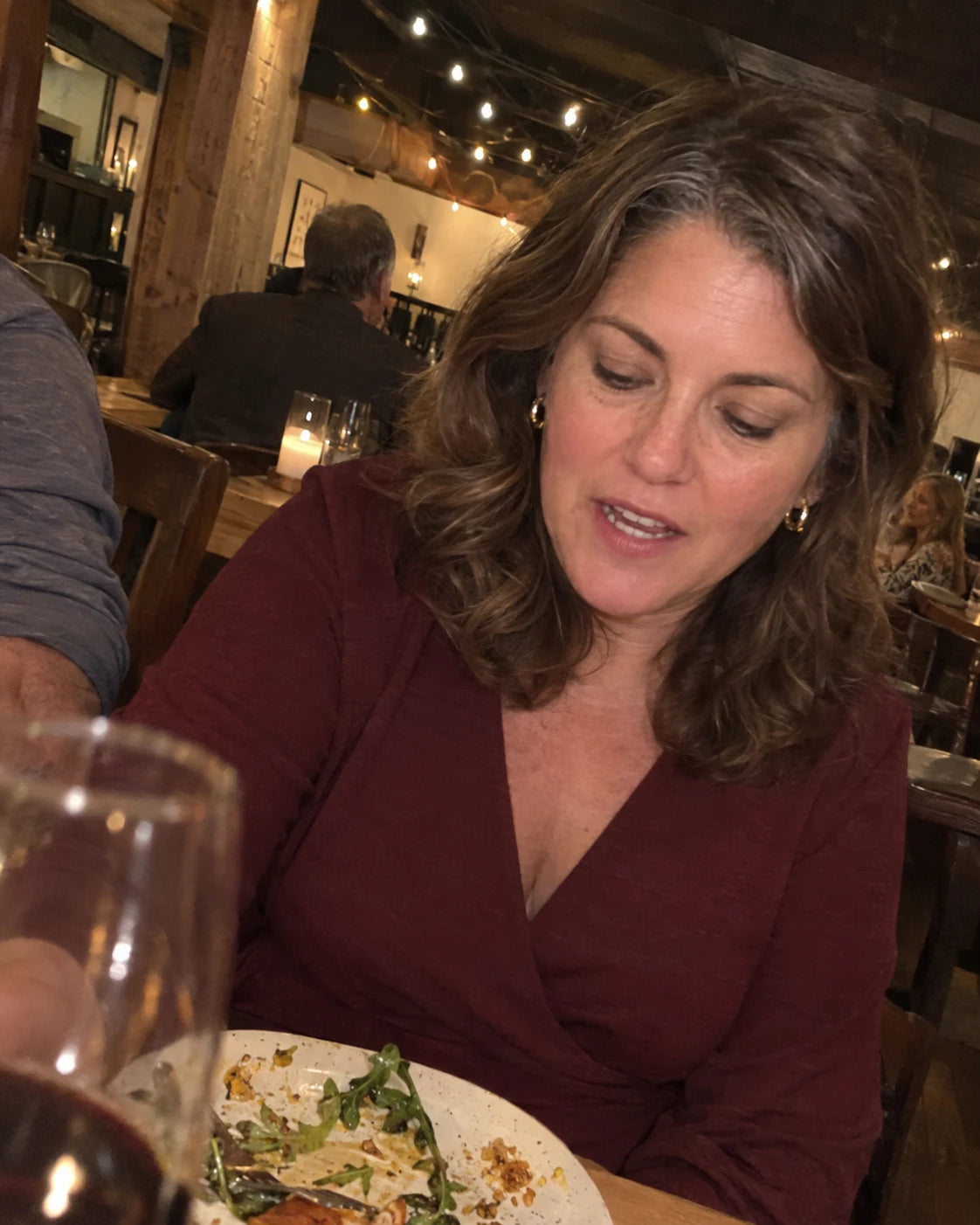 Woman mid-conversation at the dinner table