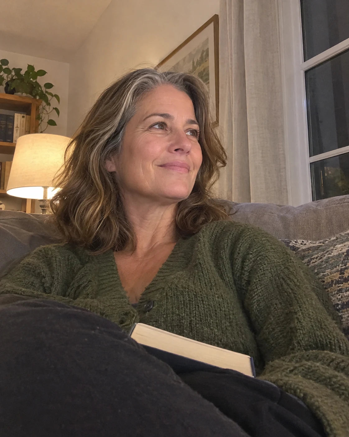 Denise relaxed and content on the couch in the evening