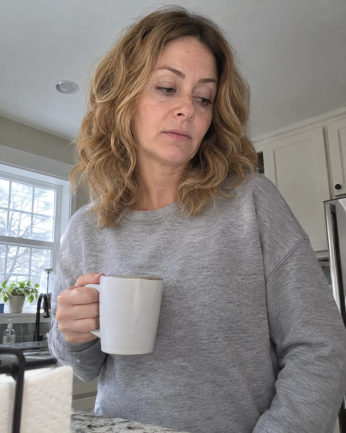 Tired woman holding coffee in the morning